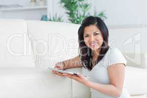 Woman sitting on the floor while holding a tactile tablet