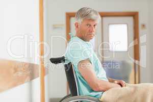 Man sitting in a wheelchair while looking at camera