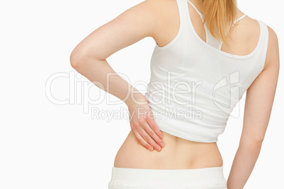 Woman standing while massaging her back