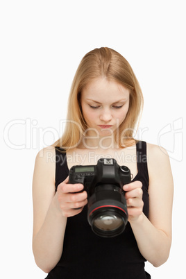 Woman looking at the screen of her camera