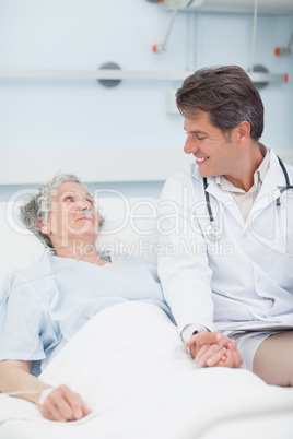 Doctor taking hand of a patient