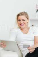 Woman with a credit card and a tablet