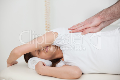 Woman lying on the side while being massaged