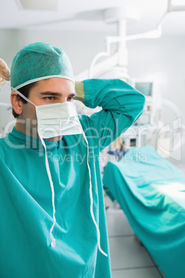 Close up of a surgeon putting his mask