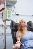 Woman receiving a blood donation while sitting