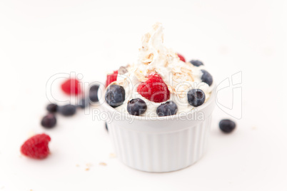 Jar  of whipped cream and berries