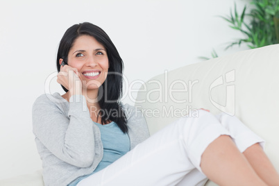 Woman smiling while telephoning