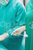 Close up of a surgical scissors holding by a nurse