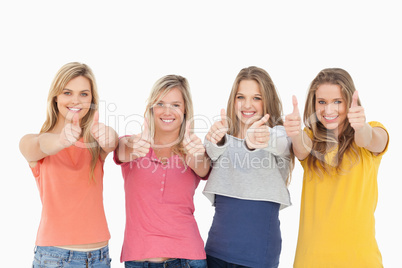 Girls sticking their thumbs up
