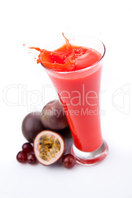 Overflowing glass of berries juice