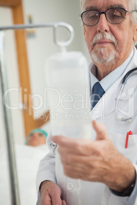 Doctor checking an intravenous drip