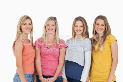 Four girls smiling as they look at the camera