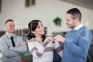 Couple holding keys while looking at each other