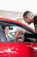 Smiling woman receiving car keys