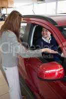 Businesswoman presenting the car to a client