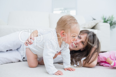 Baby on all fours next to his mother