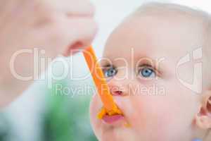 Baby looking at his mother while eating