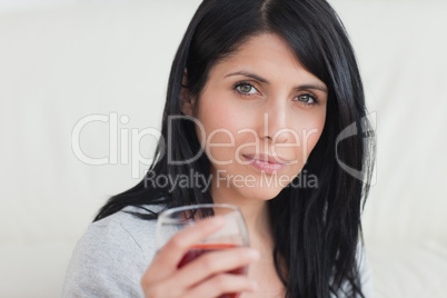 Woman holding a glass full of red wine