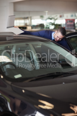 Dealer looking into a car