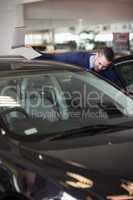 Dealer looking into a car