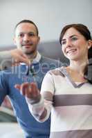 Couple receiving keys from a car dealer