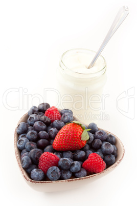 Berries in a heart shaped bowl with yogurt