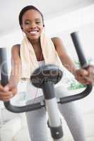 Front view of a black woman doing exercise bike