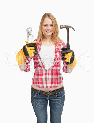 Cheerful woman holding tools
