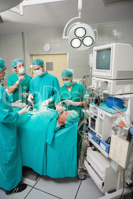 Patient lying on a medical bed undergoing an operation