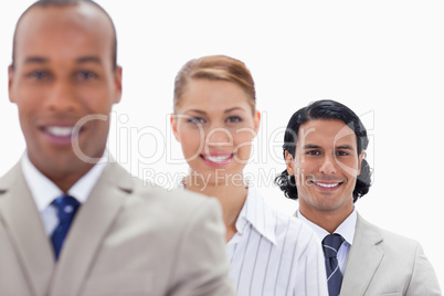Big close-up of workmates smiling in a single line
