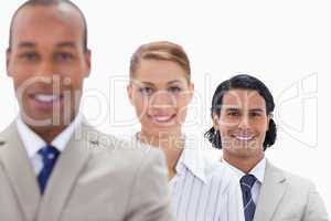 Big close-up of workmates smiling in a single line