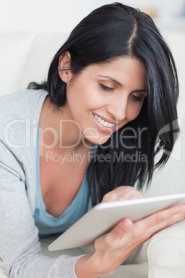 Close up of a woman typing on a tablet