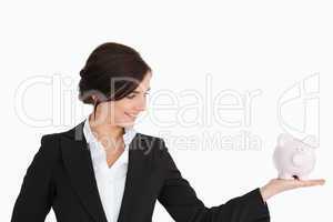 Businesswoman with a piggy-bank on her palm