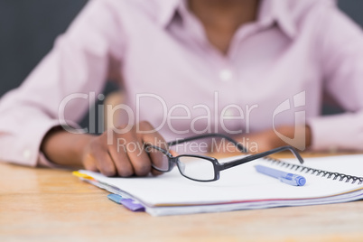 Close up of a notebook and glasses