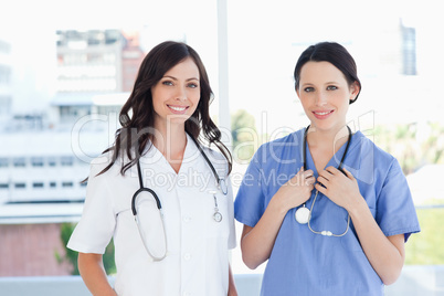 Medical interns standing upright in their short sleeve uniforms