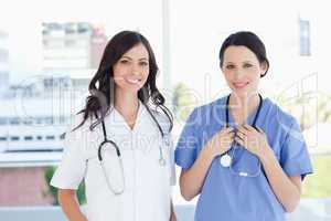 Medical interns standing upright in their short sleeve uniforms