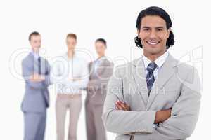 Close-up of a businessman smiling and crossing his arms with peo