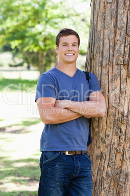Portrait of a muscled student next to a tree