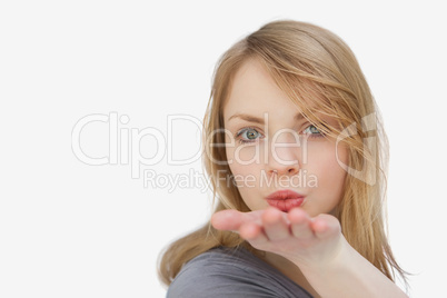 Blonde woman blowing on her hand
