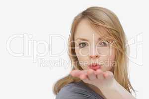 Blonde woman blowing on her hand