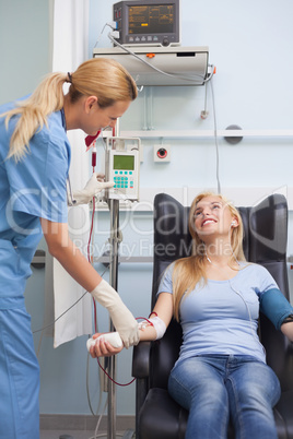 Nurse taking the pulse of a blood donor