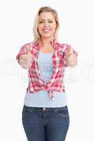 Happy blonde woman showing her two thumbs up