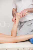 Podiatrist massaging the ankle of a woman