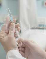 Close up of doctor preparing a syringe