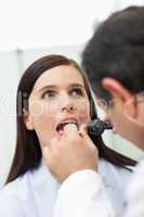 Doctor looking at the mouth of a patient