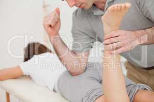 Woman lying while being massaged by her doctor