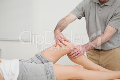 Knee of a woman being massaged by a physiotherapist