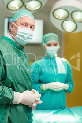 Two surgeon crossing their hands while standing