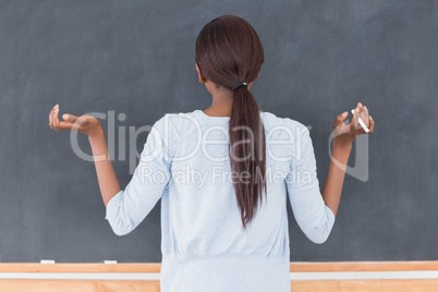 Black woman in front of a blackboard