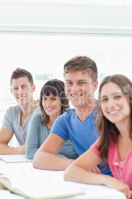 Close up side view of smiling students looking at the camera